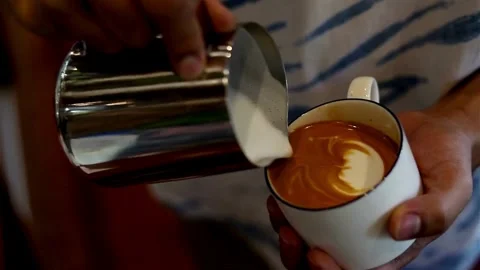 Preparing a latte coffee in the cafe. delicious hot beverages in a white cup. Stock-Footage 334648592