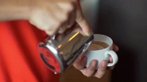 Preparing a latte coffee in the cafe. delicious hot beverages in a white cup. Stock Footage 334649827