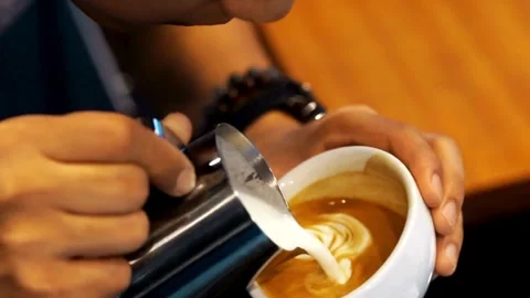 Preparing a latte coffee in the cafe. delicious hot beverages in a white cup. 動画素材 334649943