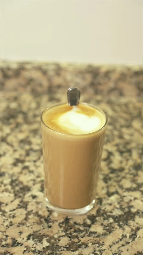 Preparing a latte macchiato in a glass on a marble countertop Video stock 331074130