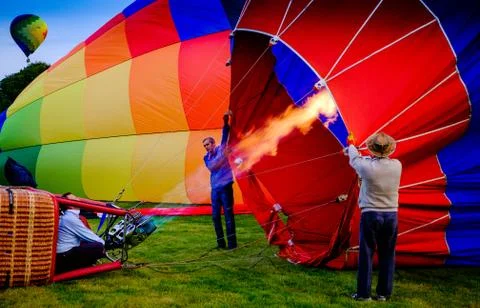 Preparing to launch a hot air balloon at dawn at a balloon festival in centra Stock Photos
