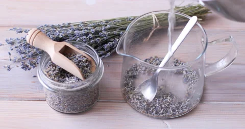 Preparing lavender tea in a glass tea pot Stock Footage 103419222