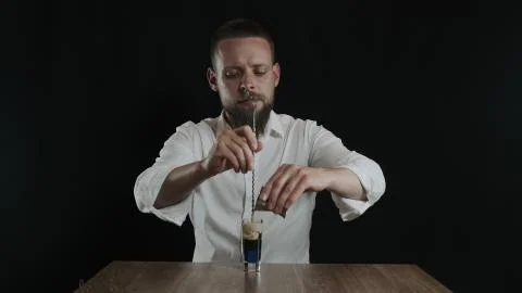 Preparing of Lexus Cocktail. Bartender pouring irish cream into glass Stock Photos