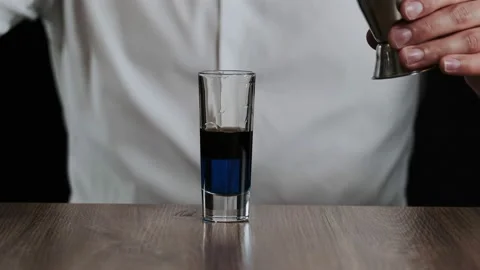 Preparing of Lexus Cocktail. Close up pouring sambuca into a glass Stock Footage 132719659