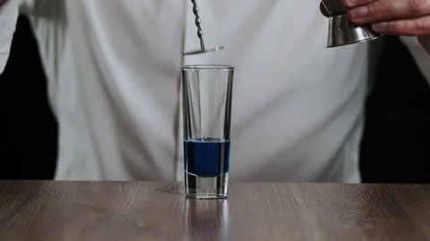Preparing of Lexus Cocktail. Close up pouring coffee liquor into a glass Stock Footage 132720408