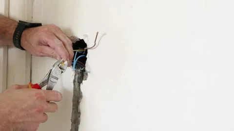 Preparing light switch electrical wires with stripper tool Stock Footage 339298338