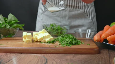 Preparing a marinade for Roast Chicken made from spices, basil leaves, parsley. Stock Footage 145106176