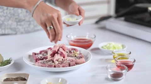 Preparing Marinated Lamb Chops with Spices and Fresh Ingredients Stock-Footage 336536647