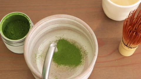 Preparing matcha tea process. Pouring hot water into matcha powder in ceram.. Stock Footage 326049019