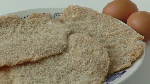 Preparing a meal of breaded cutlets Stock Footage 50780808