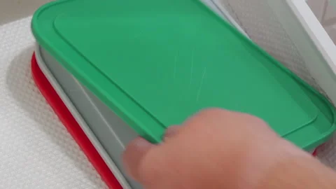 Preparing Meal: Hand Quickly Pulls Stacked Plastic Lids From Kitchen Drawer Stock Footage 321203733