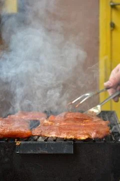 Preparing meat on a coal grill Photos