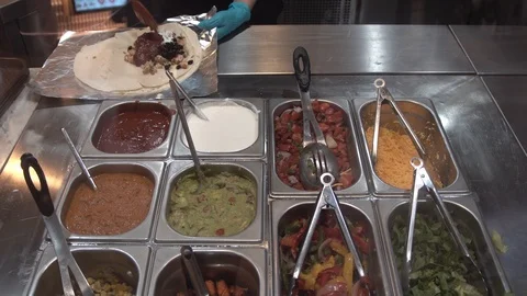 Preparing Mexican Burrito for customer. Video stock 107040438
