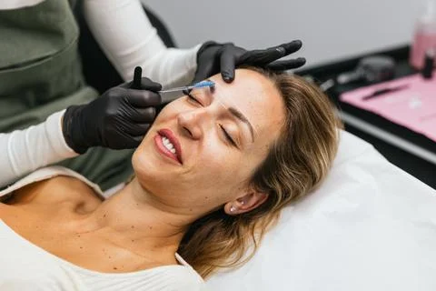 Preparing for microblading, precise eyebrow design with thread marking Stock Photos