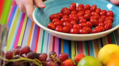 Preparing mini plum tomatoes in colorful kitchen Stockbeeldmateriaal 42184160