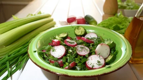 Preparing mix salad with different vegetables at home. Adding salt and pepper. Stock Footage 125215111