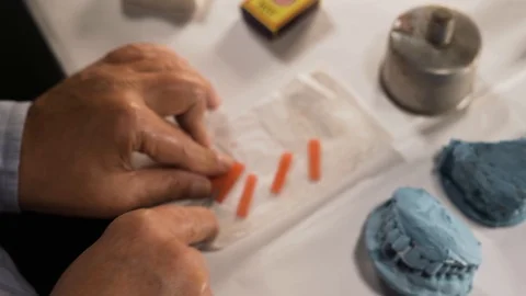 Preparing modelling wax for making artificial jaw and RPD in 4k. 
Hands, Stock Footage 108007479