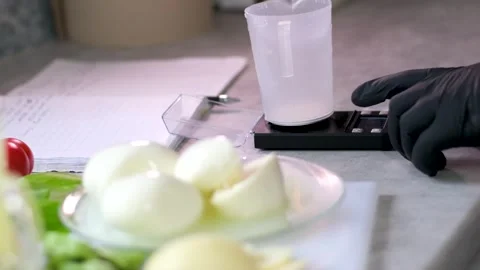 Preparing mozzarella cheese on a kitchen scale jewelry scales weighing Stock Footage 274908800