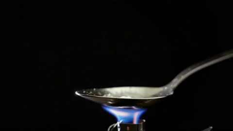 Preparing a narcotic substance in a spoon on a fire 스톡 동영상 143446957
