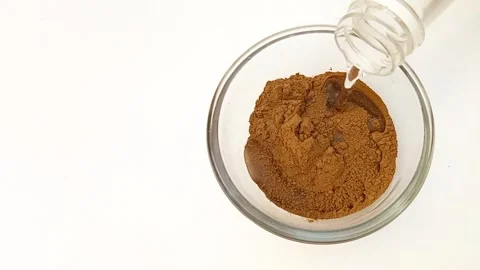 Preparing Natural Henna Paste in Glass Bowl on White Background, Mehndi Stock Footage 338233181