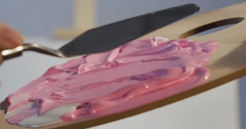 Preparing a new drawing color mix using small spatula Stock Footage 126982200