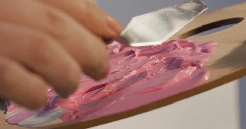Preparing a new drawing color mix using small spatula Stock Footage 126982658