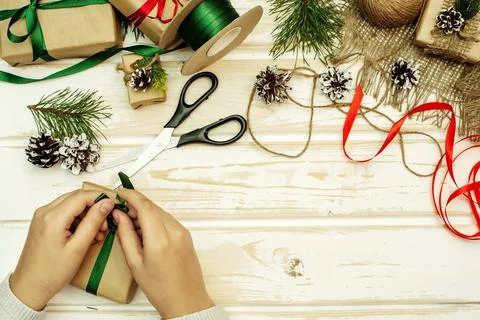Preparing for the new year. Making handmade gifts. Hands packing a gift Foto stock