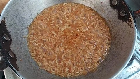 Preparing Noodles in a small wok Stock Footage 155329603