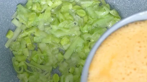 Preparing omelette with spring onions Stock Footage 73044692
