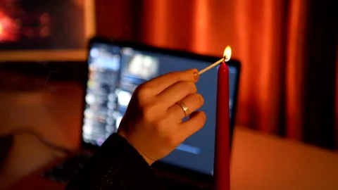 Preparing to online date candles in front of laptop Stock Footage 168758895