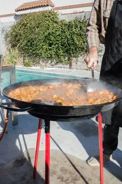 Preparing paella in the backyard Stock Photos