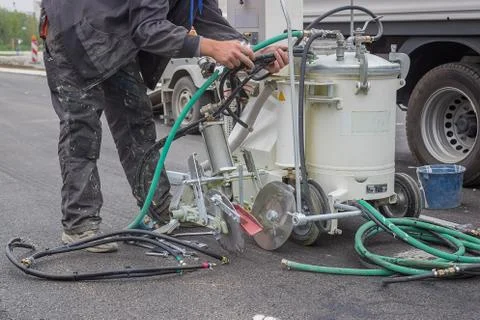 Preparing paint machine for marking new road lines Stock Photos