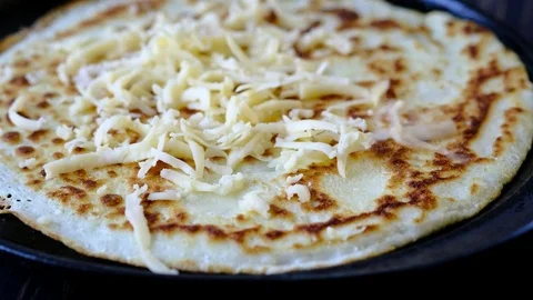 Preparing a pancake with cheese on the hot pan Stock Footage 74225541