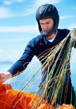 Preparing to paraglide. a man getting ready to go paragliding. Stock Photos