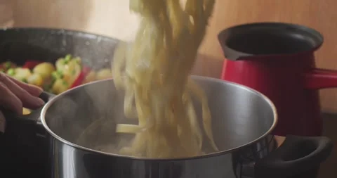 Preparing pasta in stemaing metal pan 4K video Stock Footage 297538295