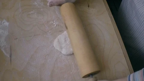 Preparing pastry with rolling pin. Flat dough. Closeup on timber board. Stock Footage 91198393