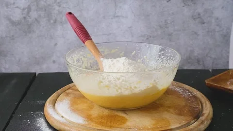 Preparing the Pie Dough. A woman's hand mixes the dough with a spatula. Stock Footage 259516640