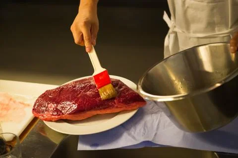 Preparing a piece of meat to be roasted Stock Photos