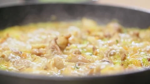 Preparing of pieces chicken meat with vegetables in a frying pan. Stock Footage 152518828