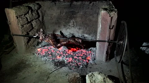 Preparing the pig on a spit, detail. Evening Stock Footage 68432327