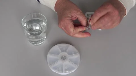 Preparing pills and water for medication Stock Footage 328996265