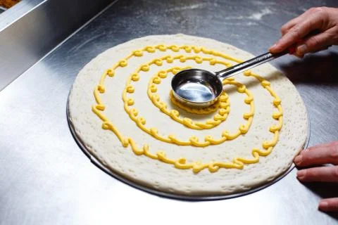 Preparing the pizza base. Applying cheese sauce Stock Photos