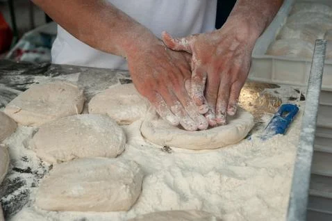 Preparing Pizza dought at the pizzeria. Stockfoto's