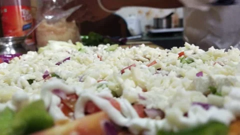 Preparing pizza putting cheese on top Video stock 238757134