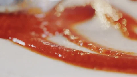 Preparing pizza. Spreading tomato sauce on dough Stock Footage 104720118