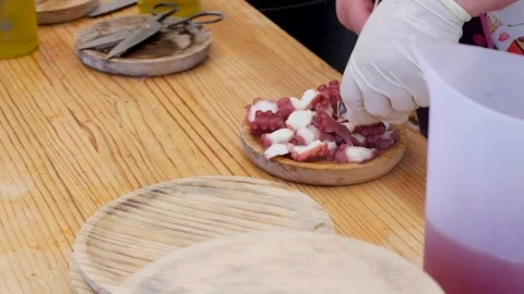 Preparing a plate of Galician octopus Stock Footage 154436718