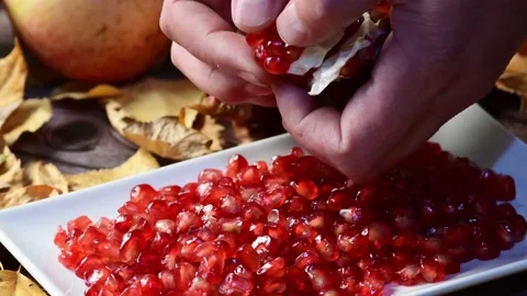Preparing a pomegranate Stock Footage 143642409
