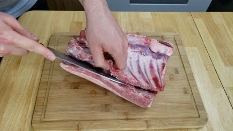 Preparing pork belly for portioning by cutting rib part first Stock Footage 159087710