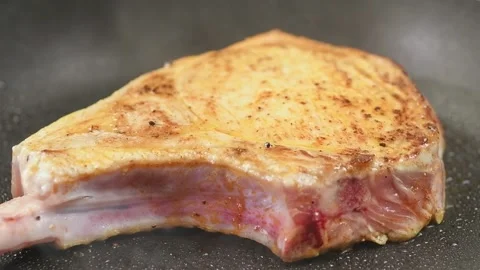 Preparing of pork chop in a frying pan. Stock Footage 165620869
