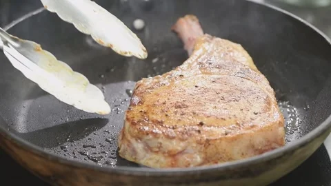 Preparing pork chop in a frying pan. Stock Footage 165621444